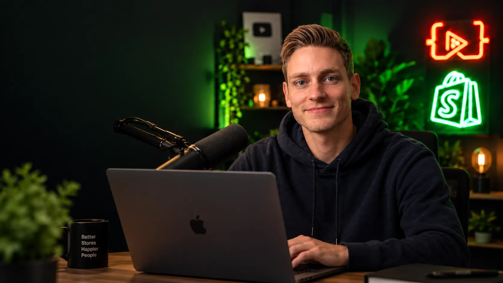 Jan at his studio desk with a laptop, microphone and mug